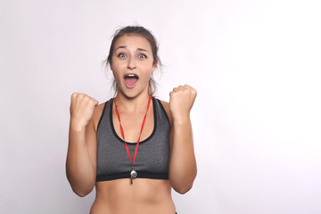 Fototapeta na wymiar Portrait of an athlete young woman with whistle.