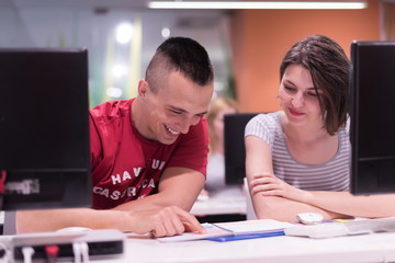 technology students group working  in computer lab school  class