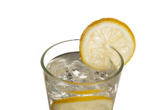 close-up cropped image of a lemon juice glass with a lemon slice.