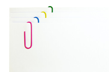 white paper with colored paper clips