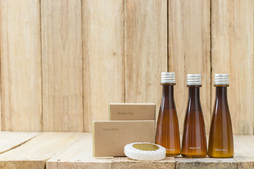 Tubes of bathroom amenity contains on wooden background