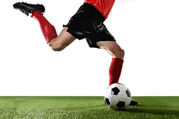Zelfklevend Fotobehang close up legs of football player in red socks and black shoes running and kicking the ball © Wordley Calvo Stock