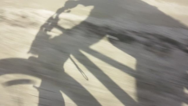 shadow of a cyclist on the road 