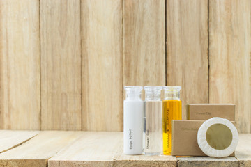 Tubes of bathroom amenity contains on wooden background