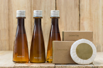 Tubes of bathroom amenity contains on wooden background