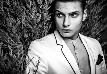 Black-white portrait of young beautiful fashionable man outdoor.
