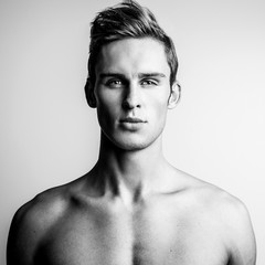 Elegant stylish handsome man. Black-white studio fashion portrait.