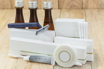 Tubes of bathroom amenity contains on wooden background