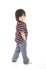 Little asian preschool boy standing isolated on white background