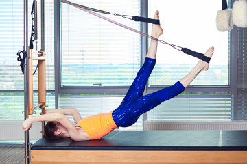 Healthy Smiling Woman Wearing Leotard Practicing Pilates in Bright Exercise Studio