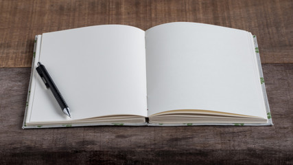 Closeup of opened handmade book on wooden background