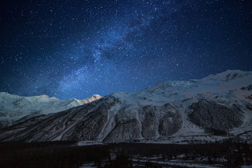 Night landscape. Starry sky with the Milky Way over the mountains.