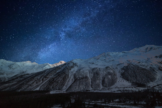 Night landscape. Starry sky with the Milky Way over the mountains.