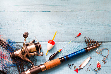 Fishing tackle on wooden blue background
