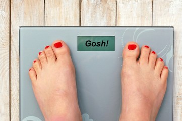 Feet on scales with text gosh in English language