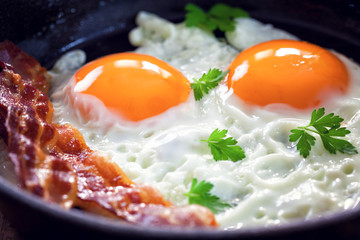 Tasty breakfast with fried eggs and bacon