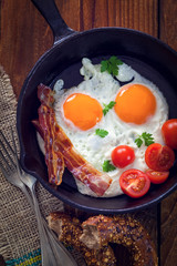 Tasty breakfast with fried eggs and bacon
