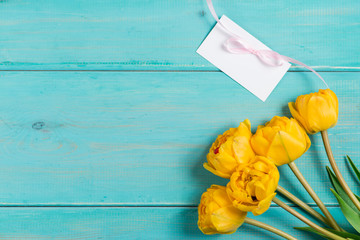 mocup yellow tulips and text space on Painted wooden background