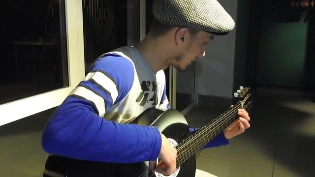Young Japanese Man Playing Six-String Guitar