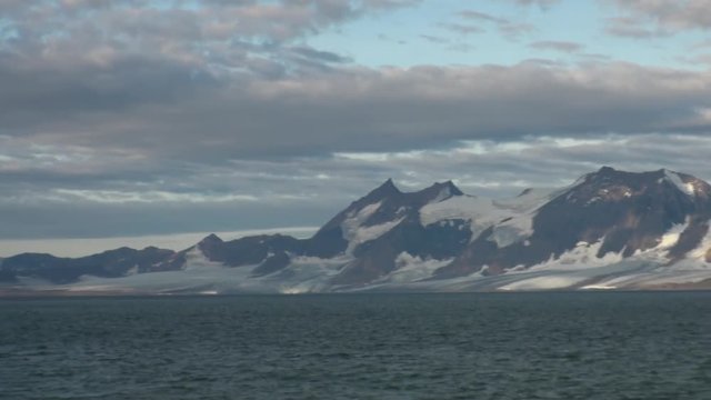 Snowy mountains and the sea in Arctic. Iceland. Fantastic wonderful amazing video grenland nature iceland. Lovely shooting the life of nature, seaside and mountains.