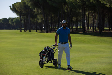 golf player walking with wheel bag