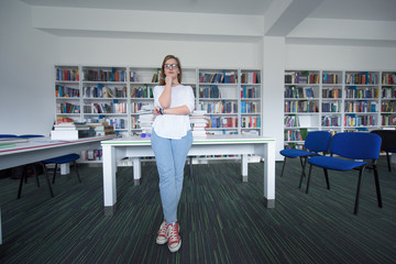 female student study in library, using tablet and searching for