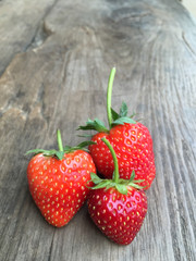 Fresh strawberries on old wooden background