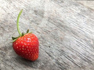 Fresh strawberries on old wooden background