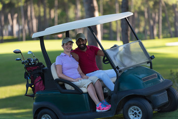 couple in buggy on golf course