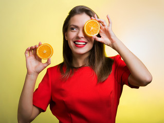 Woman in a red dress holding an orange