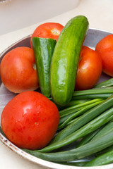 Fresh tomato cucumber and onions on the plate