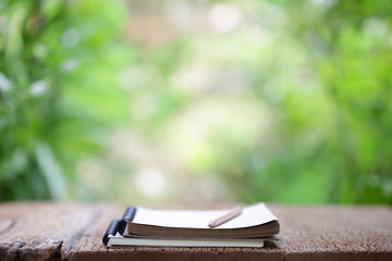 Notebook and pencil on wooden table