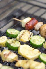 Selective focus on the meat and vegetables on the grill