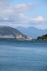 Passenger ship sails past the Torre Scola, Porto Venere on Ligurian sea Italy