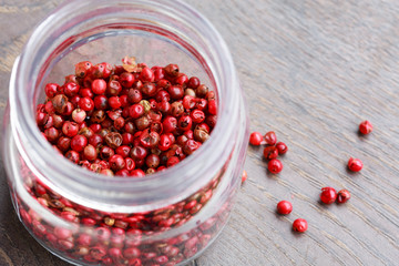 Pink peppercorns in a glass jar