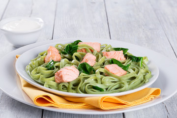 Salmon and Spinach Fettuccine pasta on white dishes