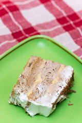 Piece of cake on the green plate