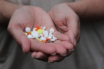 Medicinal pills on the palm.