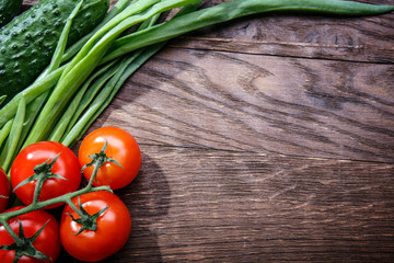 tomato cucumber green onion on a wooden