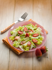 salad with lettuce zucchinis parmesan cheese and strawberries, selective focus