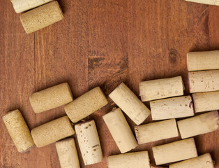 Fototapeta premium Many wine corks on dark brown wooden background texture