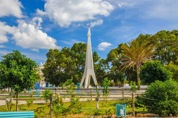 Fototapeta premium Monument with blue sky and trees near Medina in Hammamet Tunisia