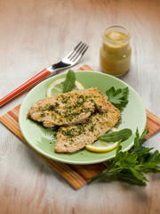 breaded cutlet with herbs and mustard, selective focus