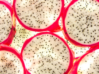 background of back lit fresh ripe pitaya dragon fruit slices