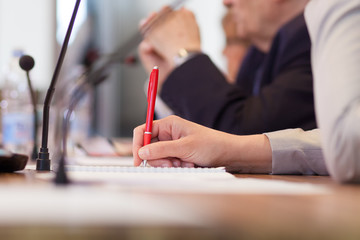 taking notes at the conference