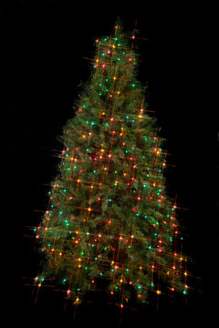 image of a christmas tree decorated with electric lights.