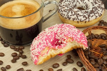 Fresh hot coffee and fresh donuts. Traditional sweets with coffee. Calorie junk food. Fresh unhealthy breakfast.

