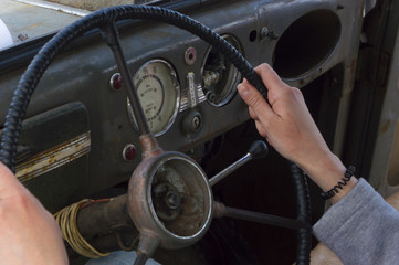 Close-up of woman at the wheel of old car