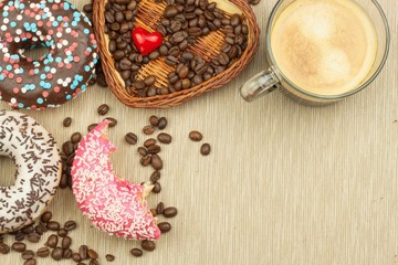 Fresh hot coffee and fresh donuts. Traditional sweets with coffee. Calorie junk food. Fresh unhealthy breakfast.
