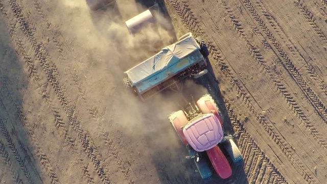 Farm tractor working in the field. Aerial footage. Slow motion.